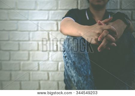 A Man Are Sad And Stressed In Black Background. Focus Of Hand Humen.