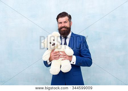 Huggably Soft And Ideal For Cuddling. Happy Businessman Hold Teddy Bear Toy Blue Background. Bearded
