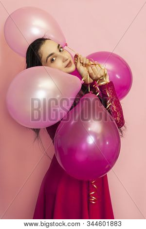 Young Pretty Woman In Red Evening Dress Holding Festive Air Balloons. Portrait Of Happy 20s Middle-e