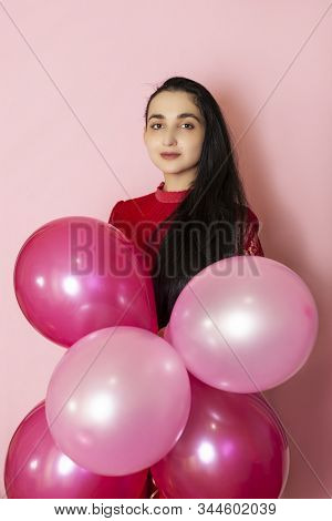 Young Pretty Woman In Red Evening Dress Holding Festive Air Balloons. Portrait Of Happy 20s Middle-e