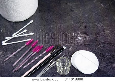 Set Of Various Mascara Brushes With Mascara Strokes On Black Background. Top Views