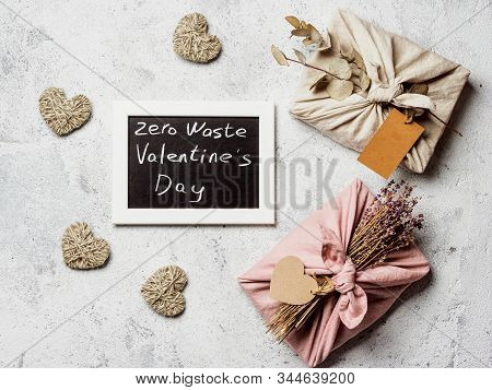Zero Waste Valentines Day Concept. Eco-friendly Gift Cloth Wrapping In Furoshiki Style And Chalkboar