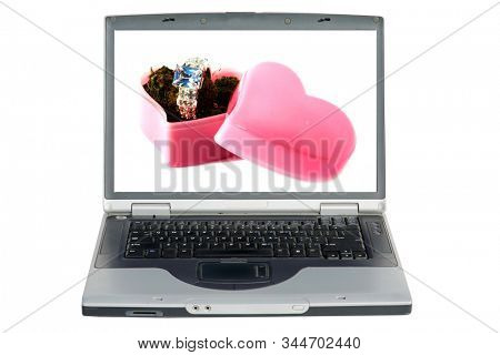 Laptop Computer. Marijuana in a pink heart shaped box with a diamond engagement or wedding ring. Valentines Day Surprise Gift. Isolated on white. Room for text. Clipping Path. Be my Valentine. 