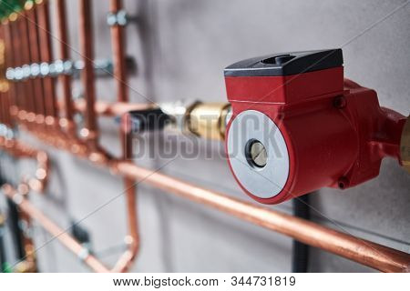 Plumbing service. copper pipeline in boiler room. Pump in front