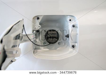 Open The Fuel Tank Cap Of White Car