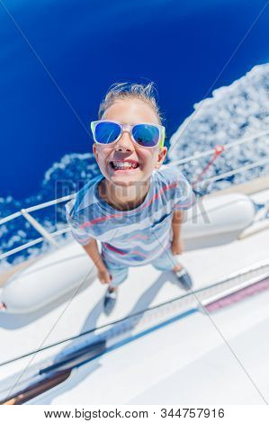 Little Boy On Board Of Sailing Yacht On Summer Cruise. Travel Adventure, Yachting With Child On Fami