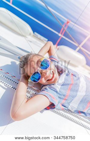 Little Boy On Board Of Sailing Yacht On Summer Cruise. Travel Adventure, Yachting With Child On Fami