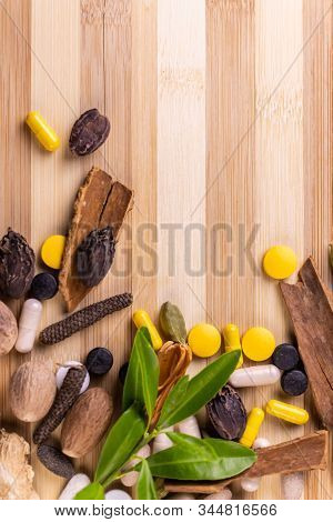 Top View Of Herbal Medicines And Green Herbs On A Wooden Background. Ayurvedic Treatment Concept