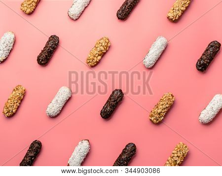 Pattern Of Different Homemade Eclairs On Pink Background. Top View Of Delicious Healthy Profitroles 