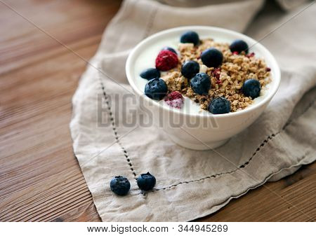 Delicious Yogurt Breakfast Bowl With Muesli And Fresh Blackberries On A Wooden Table And Linen Kitch