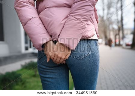 Woman Suffering From Hemorrhoid Pain Outdoors, Closeup