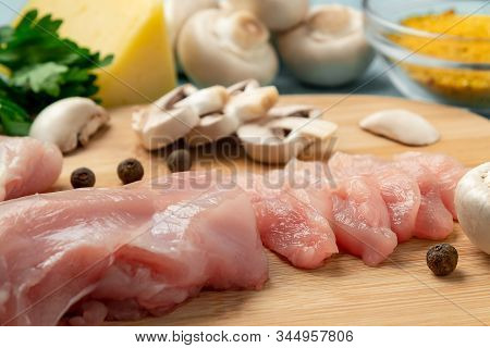 Slicing Chicken Breast Fillet For Cooking With Champignons And Cheese