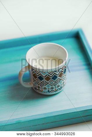 Cup Of Milk Stay On Wooden Painted Tray Close Up Photo