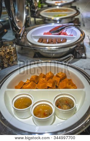 Cut In Chunks Buternut Squash And Spicy Sauce In A Serving Bowls As Part Of An Asian Style Breakfast