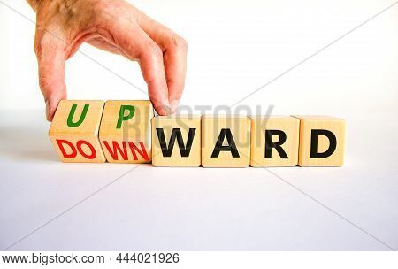 Upward Or Downward Symbol. Businessman Turns Wooden Cubes And Changes The Word 'downward' To 'upward