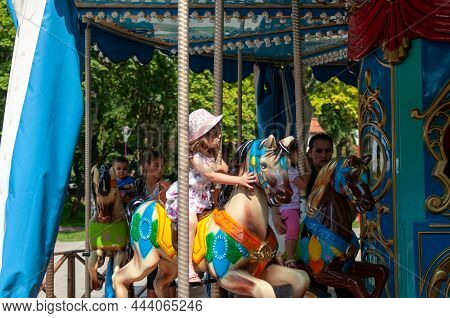 Timisoara, Romania - September 27, 2014: Young Girl Enjoying A Ride On The Merry Go Around