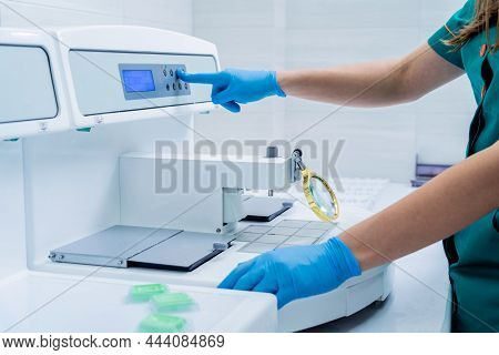 Laboratory Assistant Works At Paraffin Wax Dispenser Tissue Embedding Machine.