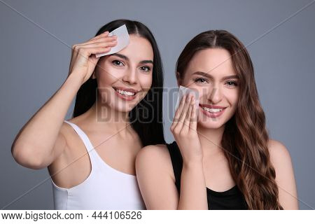 Beautiful Women Using Mattifying Wipes On Grey Background