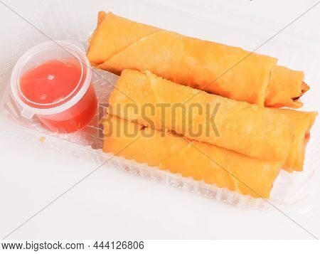 Fried Vegetable Deep Fried Spring Rolls Or Popiah With Sauce In Plastic Packaging.