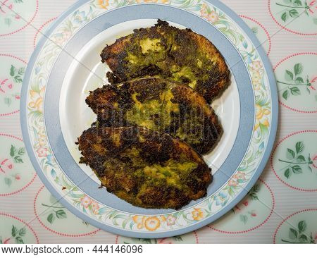 Homemade Three Slices Of Kingfish Fried To Perfection In A Green Paste Made Of Corriander Leaves, He