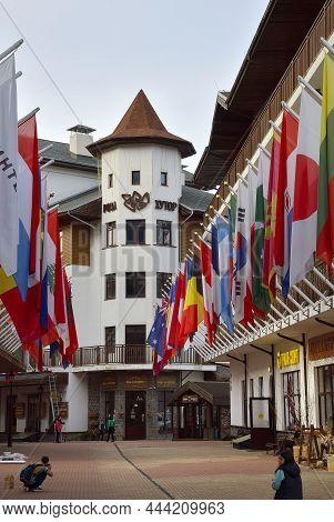 Rosa Khutor, Sochi, Russia, 11.01.2021. A Street In The Olympic Village. Alley Of Flags Among Styliz