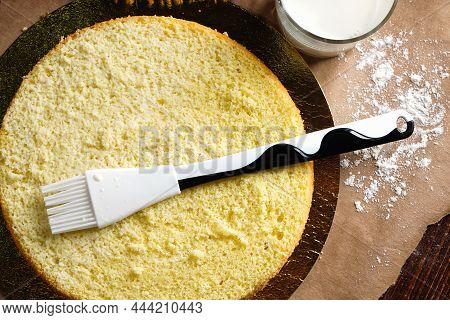 Impregnation With A Milk Of Vanilla Biscuit With A Silicone Brush. Baking A Sponge Biscuit Cake. Coo
