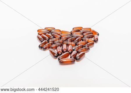 Oil Brown Heart Shape Pills D3 On The White Background. Flat Lay Capsules Vitamin D Closeup,selectiv