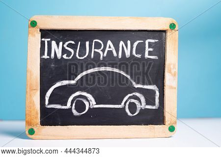 Concept Of Car Or Vehical Insurence Showing By Placing Vehicle Insurence Sign Board On Blue Backgrou