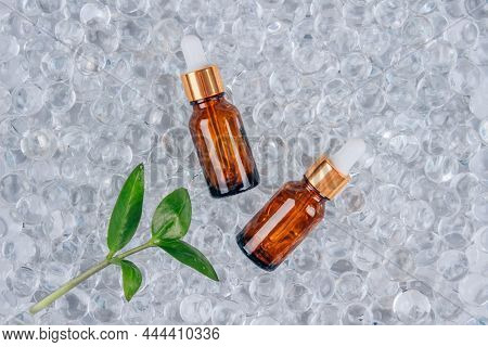 Dropper Bottles Of Face Anti Aging Serum With Collagen And Peptides On Gel Bubbles Background With C