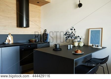 Stylish Composition Of Modern Small Kitchen Interior. Black Furniture, Workspace And Dining Space Wi