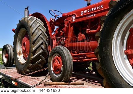 Waseca, Minnesota, June 12, 2021: The Old Restored Red Farmall Super W-6  Tractor On A Trailer Is A 