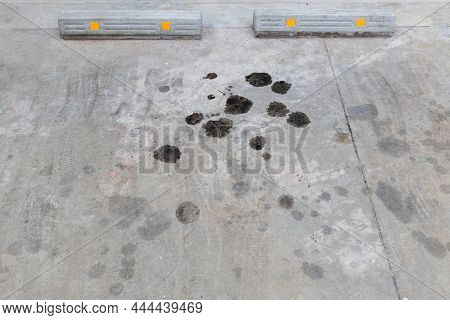 Engine Oil Leakage On Concrete Floor. Black Engine Oil On Concrete Floor. Engine Oil Leak From The E