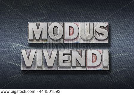 Modus Vivendi (a Way Of Living) Latin Phrase Made From Metallic Letterpress On Dark Jeans Background