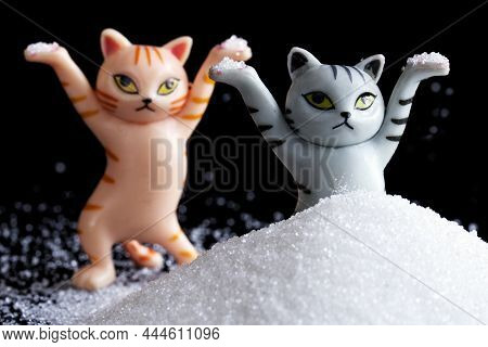 Two Funny Toy Kittens Are Having Fun In A Heap Of White Powder Or Snow. Winter Rest And Relaxation C