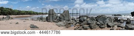 Panoramic Image Of Black Dark Boulders Lying On A Beach Along The Coast Of Axim Ghana West Africa