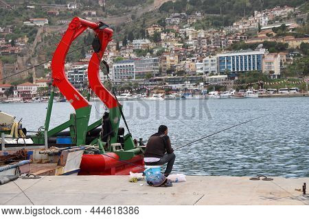 Turkey, Alanya - November 9, 2020: Elderly Couple Is Fishing In The Port Of Alanya. Pleasant Leisure