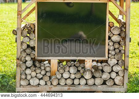 Firebox In The Garden. A Lot Of Firewood Is Stacked In A High Firebox. Energy Saving Technologies