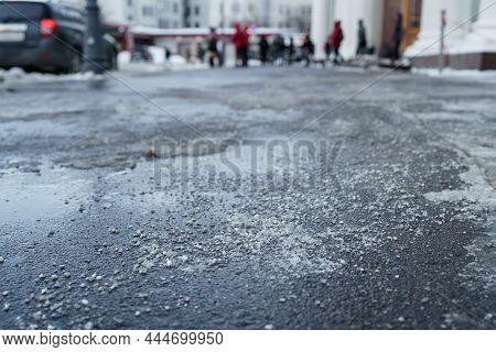 De-icing Chemical Reagent On The Road Will Make The Road Safe In Winter Time. Pavement Is Sprinkled 