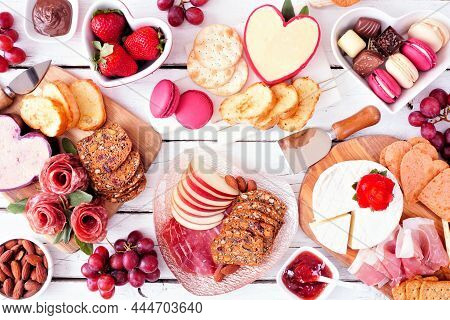 Valentine's Day Theme Charcuterie Table Scene Against A White Wood Background. Mixture Of Cheese, Me