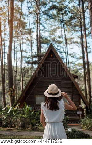 Happy Woman In White Dress And Hat Traveling In Pine Tree Forest, Tourist Visit At Doi Bo Luang, Chi