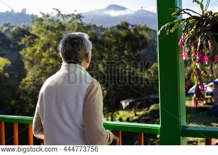 Senior Woman At A Traditional Colorful Balcony In The Beautiful Colonial Town Of Salento In The Regi