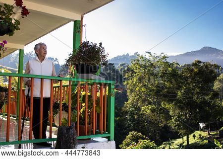 Senior Woman At A Traditional Colorful Balcony In The Beautiful Colonial Town Of Salento In The Regi