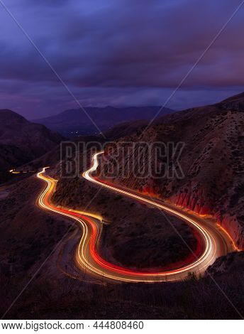 Car Trails Through Grimes Canyon Under Cloudy Skies
