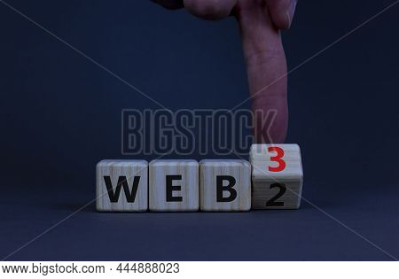 Web 2 Or 3 Symbol. Businessman Turns A Wooden Cube And Changes Words Web 2 To Web 3. Beautiful Grey 