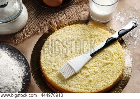 Preparing And Impregnation With A Milk Of Biscuit With A Silicone Brush. Baking A Sponge Biscuit Cak