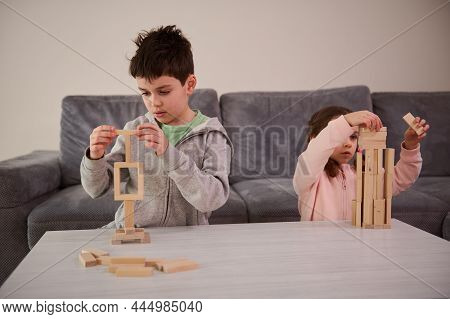 Creative Kids, Brother And Sister Concentrated On Building From Wooden Blocks, Playing Developmental