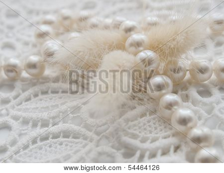 White pearl necklace and lagurus on white lace