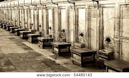 Taps and stools outside Mosque