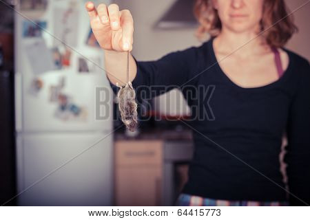 Woman Holding A Dead Mouse In Her Kitchen