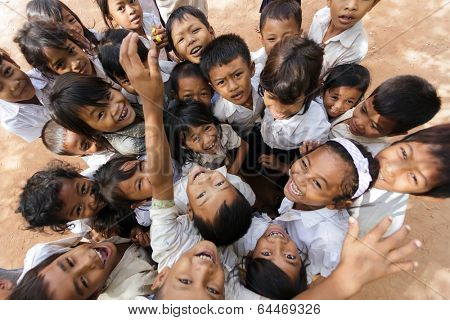 SIEM REAP -DECEMBER 04: group of joyful kids posing in a schoolyard on December 04, 2012 in Siem Reap, Cambodia